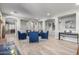 Open living space showing an easy flow to different areas, fireplace, seating, and access to another room at 15753 W Christy Dr, Surprise, AZ 85379