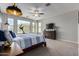Sunlit main bedroom with a view of the neighborhood, large dresser, and carpeting at 15753 W Christy Dr, Surprise, AZ 85379