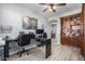 Office area with desk, shelving, and wood grain tile flooring, offering a functional workspace at 15753 W Christy Dr, Surprise, AZ 85379