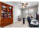Office with a built-in bookshelf, wood grain flooring, and windows for plenty of natural light at 15753 W Christy Dr, Surprise, AZ 85379