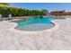 Beautiful backyard pool and spa with paver decking, mature landscaping, and lounge seating for relaxing at 15753 W Christy Dr, Surprise, AZ 85379