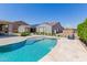Backyard with a refreshing pool, lush landscaping, and serene views of the surrounding neighborhood at 15753 W Christy Dr, Surprise, AZ 85379