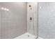 Modern shower features sleek tile work and a brushed bronze shower head and fixture at 15753 W Christy Dr, Surprise, AZ 85379
