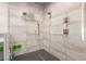 Modern shower boasting dual shower heads, tiled walls, and a tiled shower floor at 15753 W Christy Dr, Surprise, AZ 85379