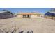 Backyard featuring a fire pit, low maintenance landscaping, and a covered patio at 15845 N 60Th Dr, Glendale, AZ 85306