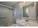 Bathroom featuring a shower, a vanity and sink, and a toilet at 15845 N 60Th Dr, Glendale, AZ 85306