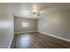 Bedroom featuring gray walls, wood-look flooring, a ceiling fan, and a window at 15845 N 60Th Dr, Glendale, AZ 85306