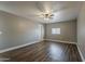 Bedroom featuring gray walls, wood-look flooring, a ceiling fan, and a window at 15845 N 60Th Dr, Glendale, AZ 85306