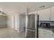 Modern kitchen with stainless steel fridge and appliances and easy access to living area at 15845 N 60Th Dr, Glendale, AZ 85306