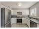 Well-lit kitchen featuring stainless steel appliances and updated countertops at 15845 N 60Th Dr, Glendale, AZ 85306
