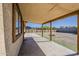 A covered patio provides shade and relaxation overlooking the backyard and landscaped area at 15845 N 60Th Dr, Glendale, AZ 85306