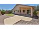 Spacious backyard featuring a covered patio, attractive landscaping, and a desert environment at 16874 W Tonbridge St, Surprise, AZ 85374