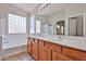 Bathroom boasting dual sinks, a soaking tub, a glass block window, and a separate shower at 16874 W Tonbridge St, Surprise, AZ 85374