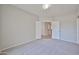 Neutral bedroom with plush carpet, ample lighting, and an open doorway at 16874 W Tonbridge St, Surprise, AZ 85374