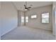 Bright and airy bedroom with multiple windows, a ceiling fan, and a neutral color scheme at 16874 W Tonbridge St, Surprise, AZ 85374