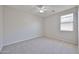 Bright bedroom featuring neutral carpet, a ceiling fan, and window with blinds at 16874 W Tonbridge St, Surprise, AZ 85374
