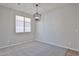 Bright dining room with carpeted floors, natural light, and modern light fixture at 16874 W Tonbridge St, Surprise, AZ 85374