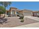Charming single-story home with a well-manicured landscape, offering a warm and inviting curb appeal at 16874 W Tonbridge St, Surprise, AZ 85374