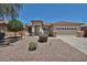 A single-story home featuring a two-car garage with a well-maintained landscape at 16874 W Tonbridge St, Surprise, AZ 85374