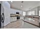 Bright kitchen featuring white cabinetry, stainless steel appliances, tile flooring, and granite countertops at 16874 W Tonbridge St, Surprise, AZ 85374