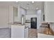Spacious kitchen featuring white cabinets, black appliances, granite countertops, and an open layout at 16874 W Tonbridge St, Surprise, AZ 85374