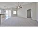 Inviting living room with sliding glass doors, a ceiling fan, and access to outdoor space at 16874 W Tonbridge St, Surprise, AZ 85374