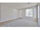 Inviting living room with bright windows, a neutral palette, and plush carpet at 16874 W Tonbridge St, Surprise, AZ 85374