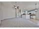 Bright living room with a seamless transition to the kitchen, perfect for entertaining guests and Gathering at 16874 W Tonbridge St, Surprise, AZ 85374