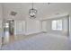 Spacious living room featuring a bright entryway, neutral colors, and plush carpet at 16874 W Tonbridge St, Surprise, AZ 85374