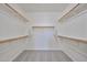 Spacious walk-in closet with ample shelving and rod space, perfect for organizing clothes and accessories at 16874 W Tonbridge St, Surprise, AZ 85374