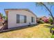 The backyard has a lush lawn, plants, covered patio, and a peaceful outdoor setting at 170 E Canary Ct, San Tan Valley, AZ 85143