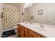 Bathroom with double sinks, a large mirror, and a tropical-themed shower curtain at 170 E Canary Ct, San Tan Valley, AZ 85143