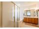 Bathroom featuring a walk-in shower, soaking tub, double sinks, and ample vanity space at 170 E Canary Ct, San Tan Valley, AZ 85143