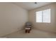 Bright bedroom with cozy chair and ottoman set by a window, creating a relaxing atmosphere at 170 E Canary Ct, San Tan Valley, AZ 85143