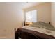 Comfortable bedroom with a wrought iron bed frame, side table, and soft natural light at 170 E Canary Ct, San Tan Valley, AZ 85143