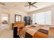 Bright bedroom featuring a queen-sized bed, natural light, and a ceiling fan at 170 E Canary Ct, San Tan Valley, AZ 85143