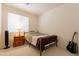 Simple bedroom featuring a wrought iron bed frame, small bedside table, and a guitar at 170 E Canary Ct, San Tan Valley, AZ 85143