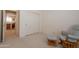 Comfortable bedroom with a view of the kitchen, featuring a cozy chair and sliding closet doors at 170 E Canary Ct, San Tan Valley, AZ 85143