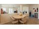 Bright dining area with a round table, four chairs, and views of the living room at 170 E Canary Ct, San Tan Valley, AZ 85143