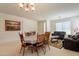 Spacious dining area featuring a wooden table, seating, and natural light with art at 170 E Canary Ct, San Tan Valley, AZ 85143