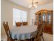 Traditional dining room features a wood table, chairs, china cabinet and chandelier at 170 E Canary Ct, San Tan Valley, AZ 85143
