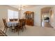 Open-concept dining room with a wooden dining set, china cabinet, and flowing layout at 170 E Canary Ct, San Tan Valley, AZ 85143