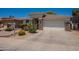 Welcoming single-story home with desert landscape, rock accents, and a two-car garage at 170 E Canary Ct, San Tan Valley, AZ 85143