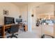 Bright home office with multiple monitors, a desk, and an exercise treadmill nearby at 170 E Canary Ct, San Tan Valley, AZ 85143