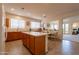 Eat-in kitchen featuring an island, wood cabinets, modern appliances and lots of natural light at 170 E Canary Ct, San Tan Valley, AZ 85143