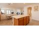 Kitchen with center island featuring wooden cabinets, an eat-in dining space and views to additional living area at 170 E Canary Ct, San Tan Valley, AZ 85143