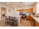 Spacious eat-in kitchen features wood cabinets, stainless appliances, and an island with bar seating at 170 E Canary Ct, San Tan Valley, AZ 85143