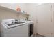 Laundry room is equipped with a front-load washer and dryer and a convenient storage shelf at 170 E Canary Ct, San Tan Valley, AZ 85143