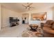 Bright living room offering carpet, a ceiling fan, and an open layout to the kitchen at 170 E Canary Ct, San Tan Valley, AZ 85143