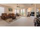Spacious living room with carpet, a ceiling fan, and views of the backyard at 170 E Canary Ct, San Tan Valley, AZ 85143
